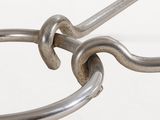 a close up of a metal object with a hook on it