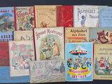 several children ' s books are lined up on a black surface