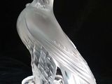 a glass sculpture of an eagle on a clear base