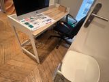 a desk with a computer on it in the corner of a room