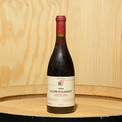 a bottle of wine sitting on top of a barrel