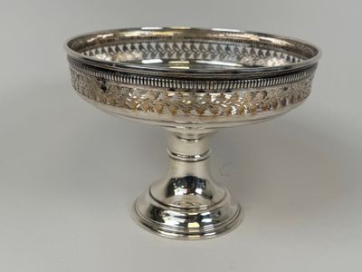 an image of a silver plate with a decorative design on it
