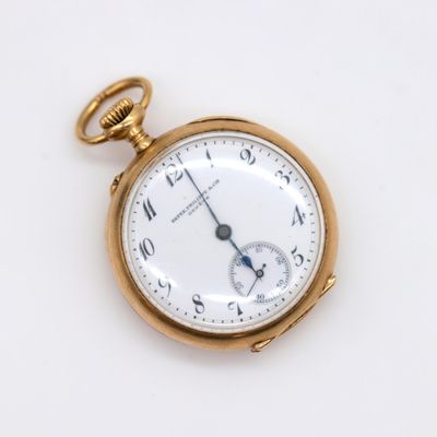 an antique pocket watch on a white surface with a gold case