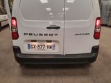 the back of a white van parked in a garage