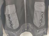 the jacket is grey and has silver sequins on it