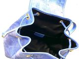 a blue purse that is open on a white surface