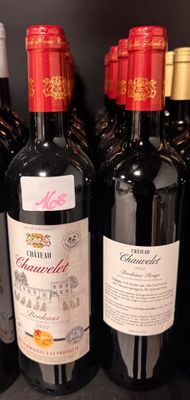 several bottles of red wine are lined up on a shelf