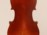 an old violin hanging from the back of a white wall