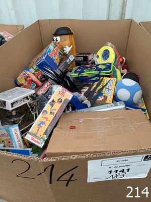 a cardboard box full of toys for sale on the street