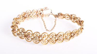 a close up of a gold chain bracelet on a white background