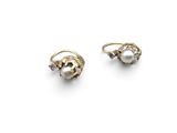 pair of pearl and diamond earrings on a white background