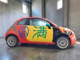 a small car with chinese writing on the side of it