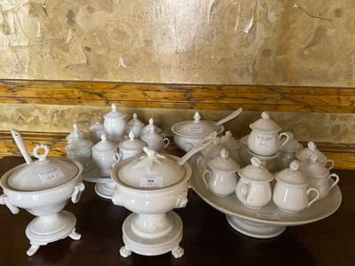 a lot of white dishes and cups on a table
