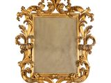 une image d'un miroir encadré d'or sur un fond blanc