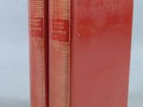two red books sitting on top of each other on a table