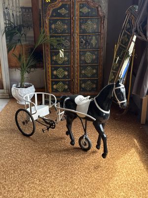 a toy horse pulling a carriage in a living room