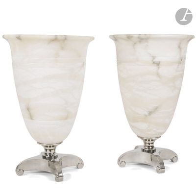 pair of white marble vases sitting on top of a metal stand
