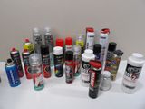 many different types of spray paint on a white table