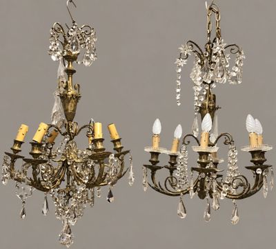 two antique chandeliers hanging from the ceiling in a room