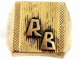 an image of a gold ring with the letters a and k on it