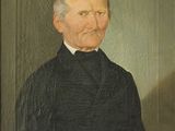 portrait d'un homme vêtu d'un manteau noir et d'une chemise à col blanc