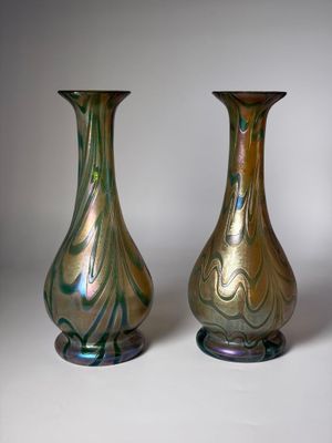 two vases sitting side by side on a white surface