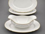 a set of three white and gold dinner plates with gold trim