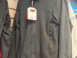 two jackets that are hanging on a rack in a store