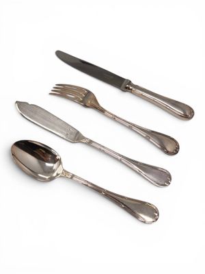 four forks and two spoons on a white surface