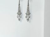 a pair of diamond earrings on a white background