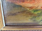 an oil painting of a fish in a gold frame on a table