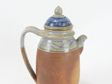 a brown and blue coffee pot with a lid