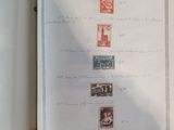 an open book with stamps on it on a table
