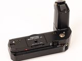 a black camera that is sitting on a white surface