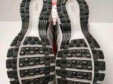 the soles of a pair of running shoes on a white surface