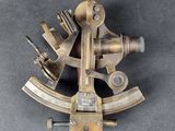 an old brass sexet on a gray surface