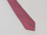 a close up of a red tie on a white table