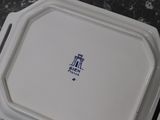 a white tray that has a blue and white logo on it