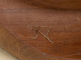 a close up of a wooden object with a letter k on it