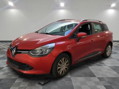 a red car is parked in a room with a checkered floor