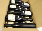 plusieurs bouteilles de vin se trouvent dans un carton sur une table