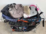 a shopping cart full of clothes and bags