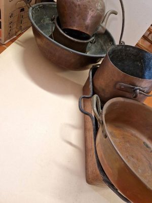 several pots and pans are sitting on a counter in a kitchen