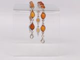 pair of earrings with orange glass beads and silver chains