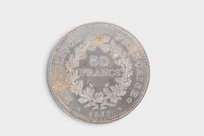 an old silver coin with a wreath on top of it