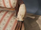 a wooden chair with a striped upholstered seat