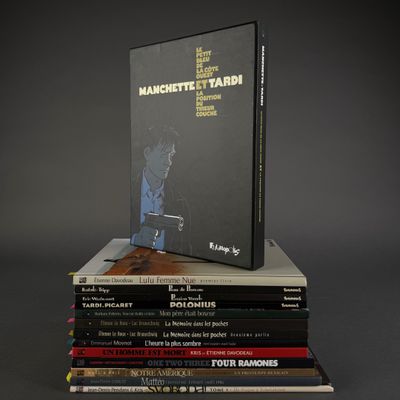 many books stacked on top of each other on a table