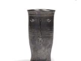 a black vase with a face on it on a white background