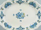 a blue and yellow plate with blue flowers on it