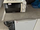 un micro-ondes et un lave-vaisselle posés sur un plan de travail dans une cuisine